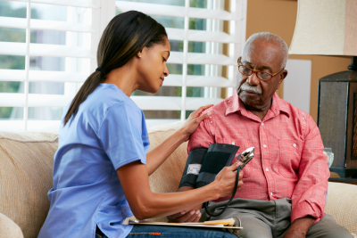 nurse checking a senior's bloog pressure