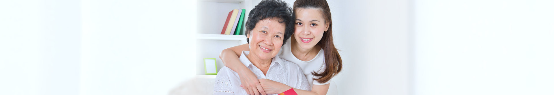 senior woman with her daughter hugging her